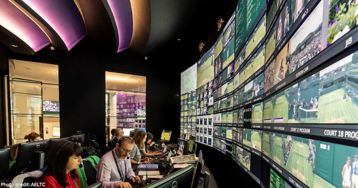 The AELTC broadcast control room, with rows of screens showing live tennis coverage.