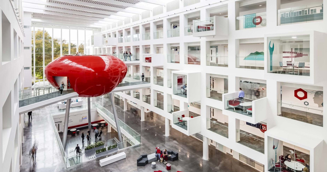 The Spark at Southampton Solent University: a white atrium with a red pod suspended above the floor.